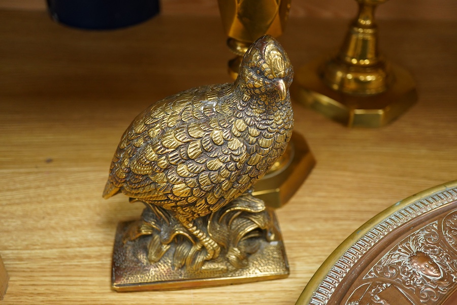 A group of copper and brassware to include candlesticks and an alms dish, 45cm in diameter